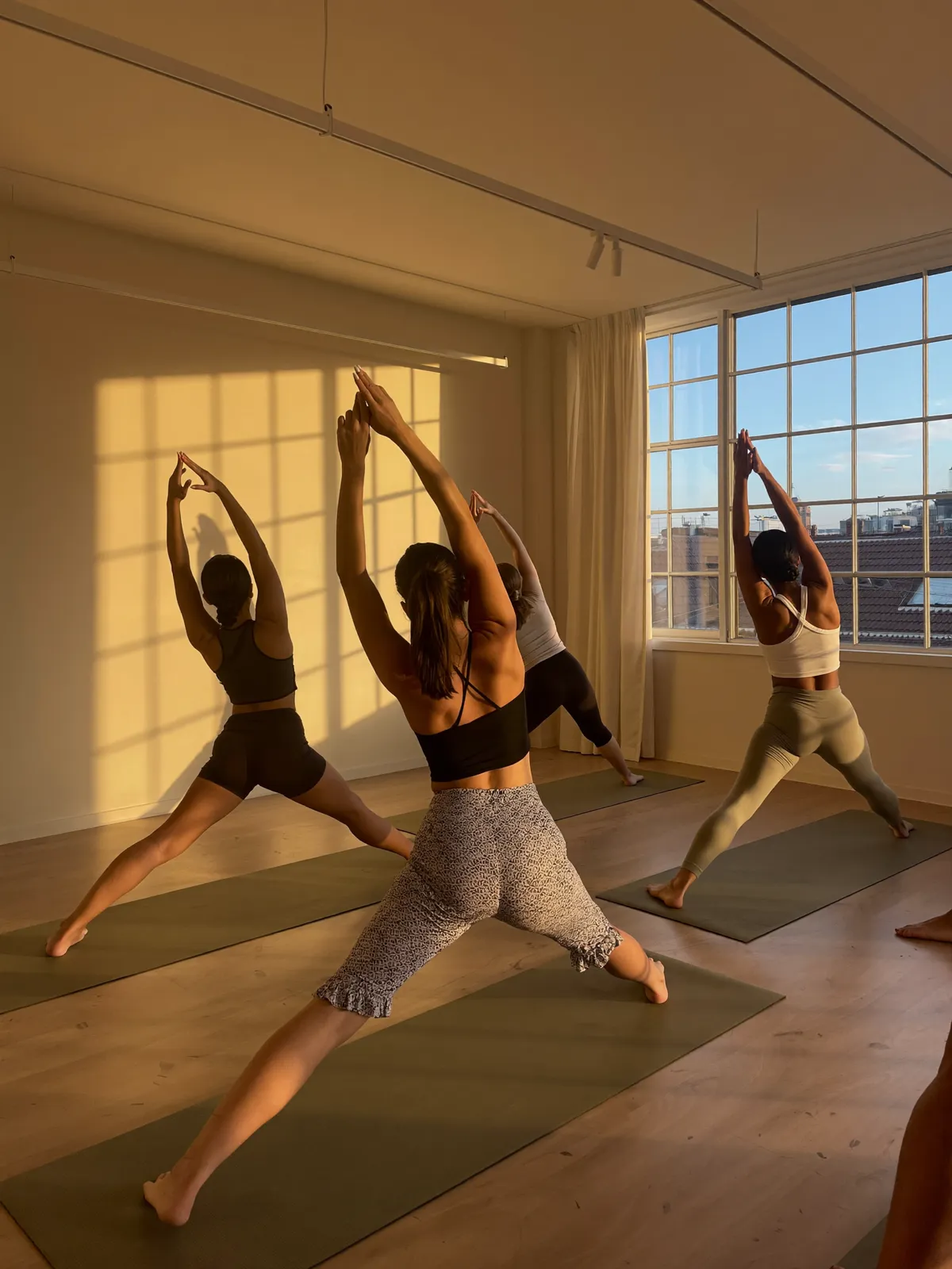 A vinyasa class moving together at dawn